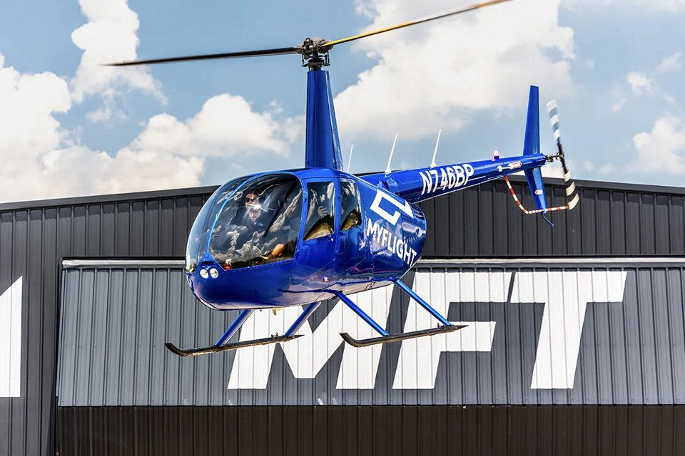 A helicopter waits on the tarmac, ready for takeoff
